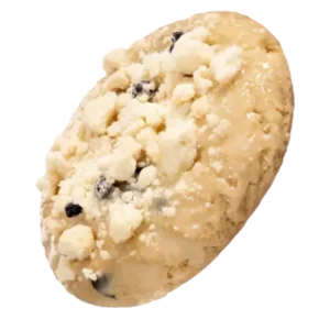 A blueberry muffin cookie topped with fresh blueberries and sprinkled with white crumbs on a wooden surface.
