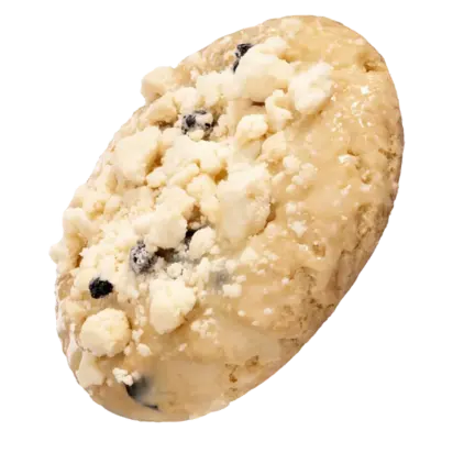 Crumbl Cookies Last Week menu 8 A blueberry muffin cookie topped with fresh blueberries and sprinkled with white crumbs on a wooden surface.